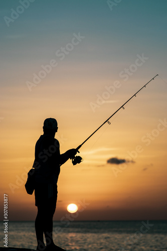 silhouette of fisherman fishing during sunset, Havana, Cuba