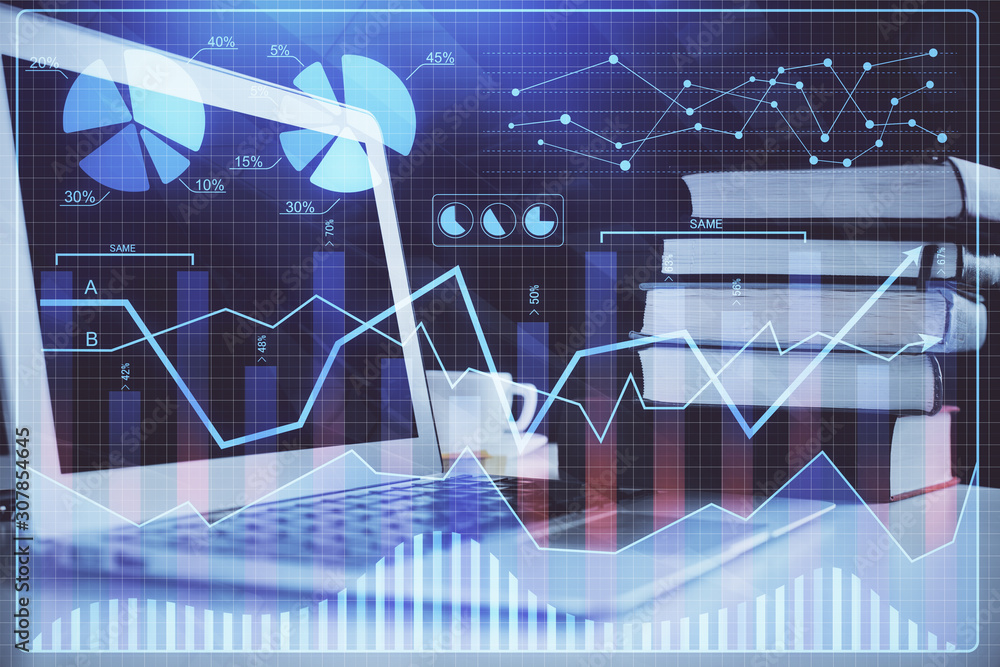 Financial chart drawing and table with computer on background. Multi exposure. Concept of international markets.