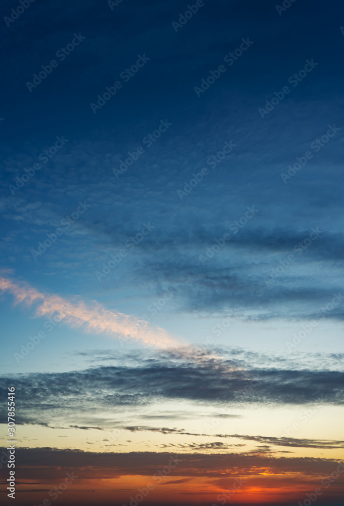 Obraz premium Fantastic clouds at sunrise, vertical panorama