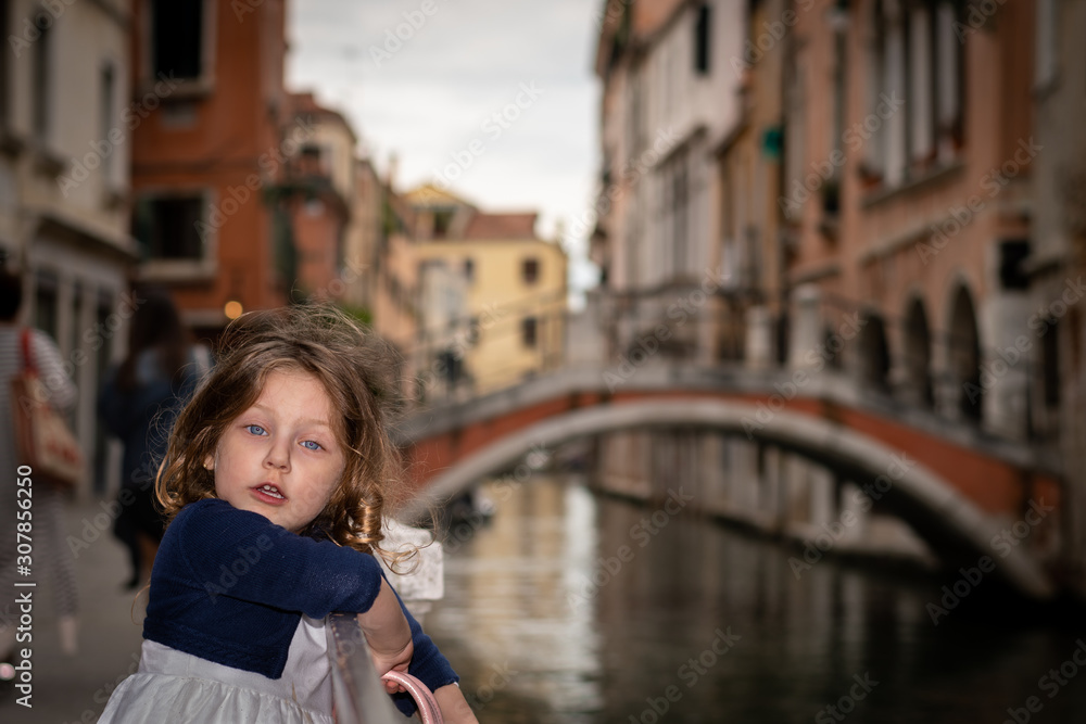 Obraz cute little girl near a water canal in Venice italy