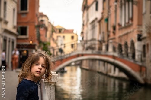 cute little girl near a water canal in Venice italy © Florincristian