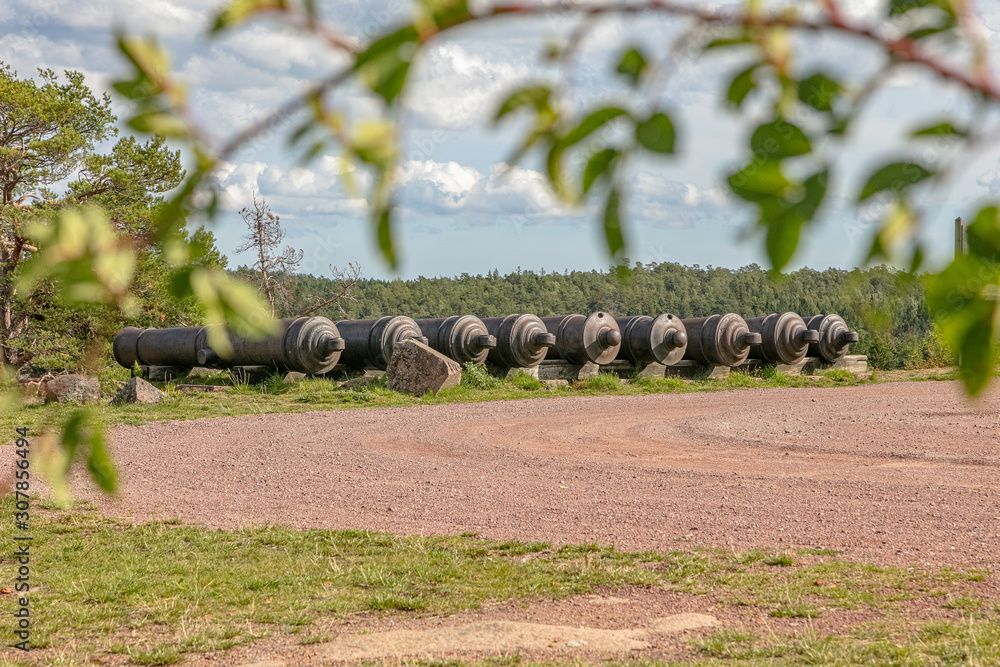 Obraz premium Ancient cast iron cannons, Bomarsund fortress, Sund, Aland Islands, Finland The old ruins of a fortress Red brick