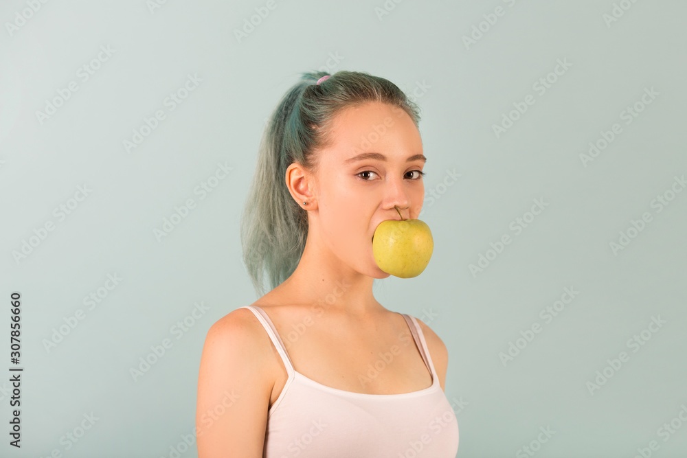 beautiful slim young woman in sportswear with an apple in her hand beautiful slim young woman in sportswear with an apple in her hand