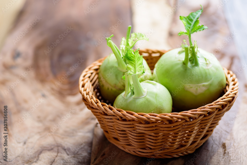 Fresh kohlrabi in basket on wooden background Fresh kohlrabi in basket on wooden background