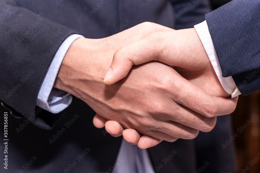 Close up business people shaking hands finishing up a meeting. businessman handshake for successful.