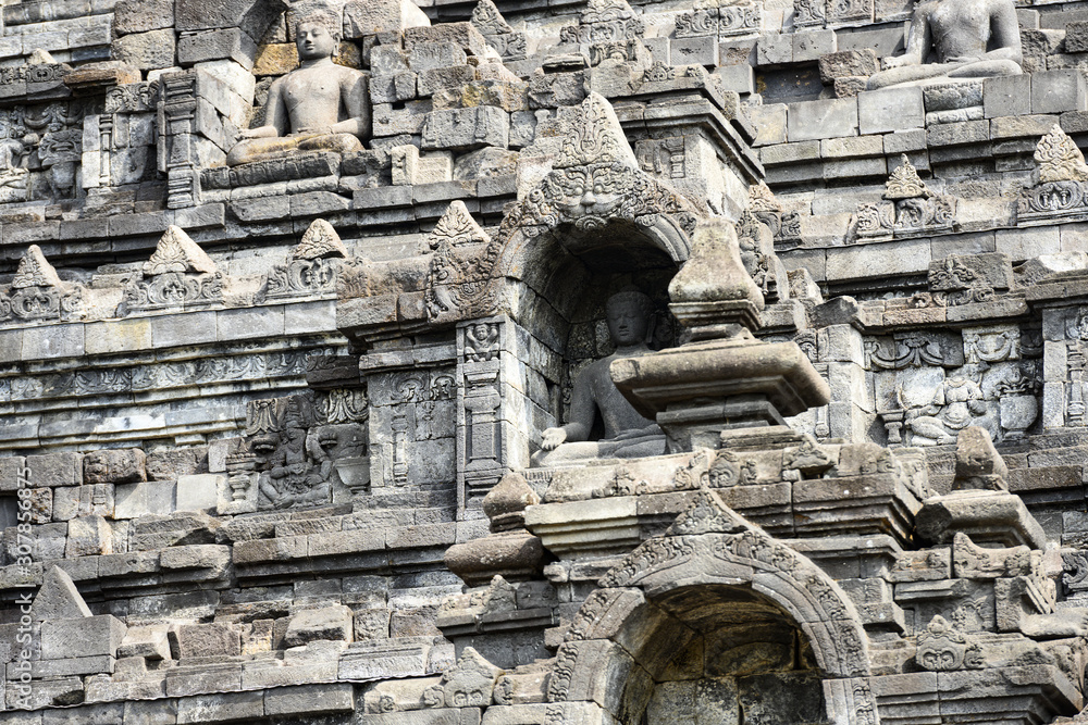 Fototapeta premium (Selective focus) Stunning view of the Borobudur Temple decorated with beautiful relief panels and Buddha statues. Borobudur is a Mahayana Buddhist temple in Central Java, Indonesia.