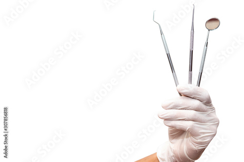 The dentist is holding the dentist tools isolated on white background.