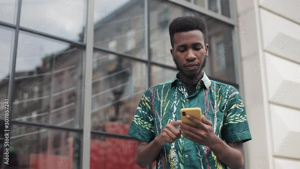Millennial guy scrolling smartphone screen. Millennial guy scrolling smartphone screen.