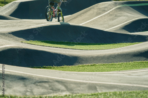 bicicle on a pump track park. Asphalted bicycle race track, pump track, kids playground photo