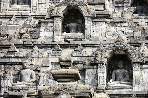 (Selective focus) Stunning view of the Borobudur Temple decorated with beautiful relief panels and Buddha statues. Borobudur is a Mahayana Buddhist temple in Central Java, Indonesia. photo