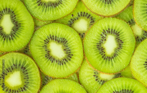 Horizontal image of kiwi slices in the foreground. Food concept, background. Flat lay.