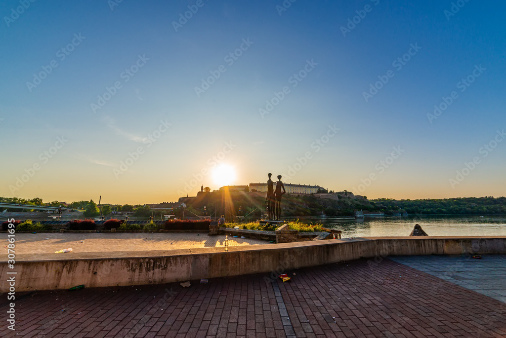 Novi Sad, Serbia June 02, 2019: Monument to the victims of fascism in Novi Sad, Serbia, Petrovaradin fortress and Danube's shore. Novi Sad and sunrise.