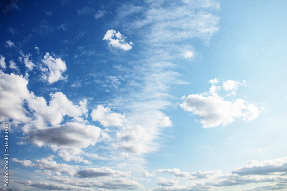 Summer view with light white clouds against the blue sky at noon Summer view with light white clouds against the blue sky at noon
