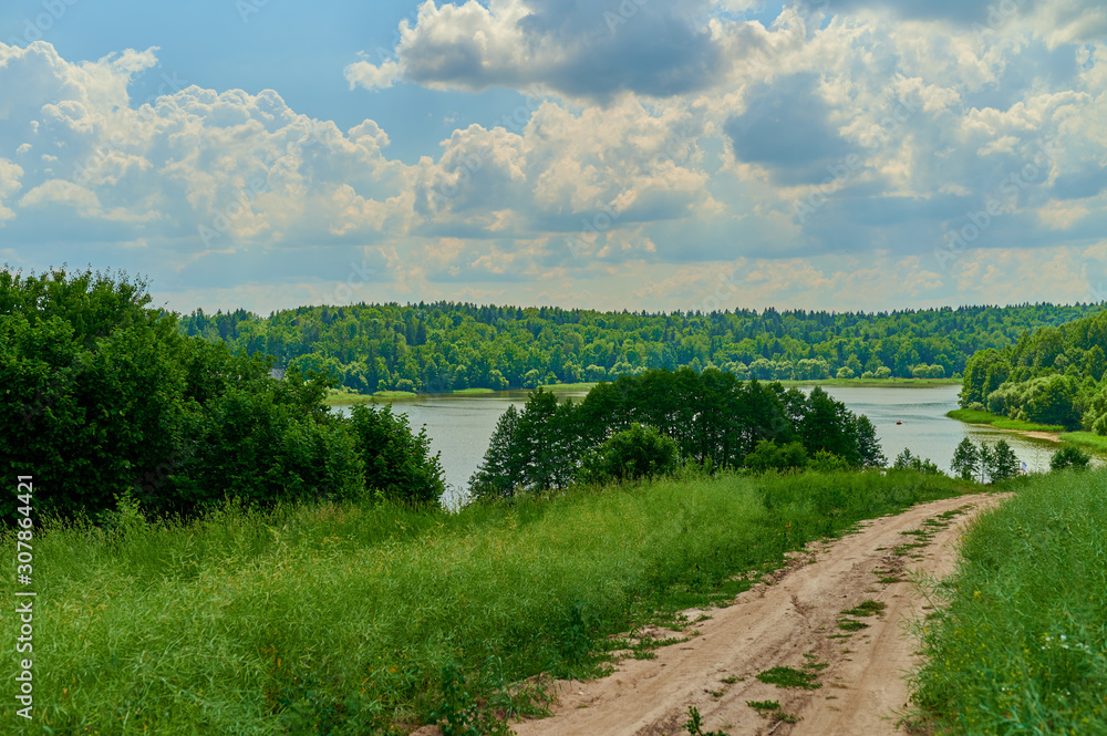 Obraz premium Peaceful rural summer european landscape with green trees and water