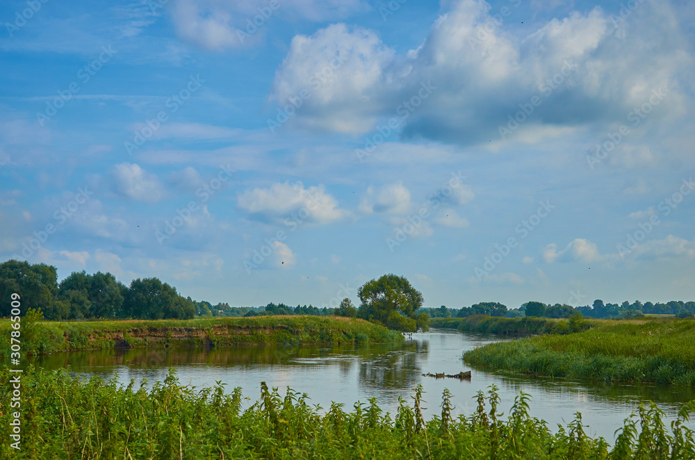 Peaceful rural summer european landscape with green trees and water Peaceful rural summer european landscape with green trees and water