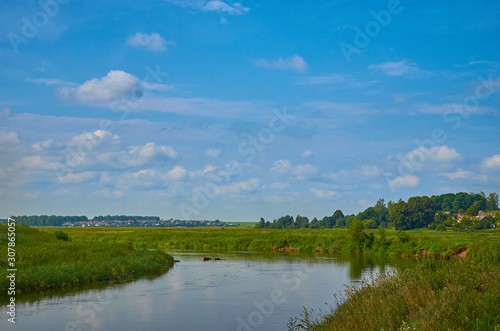 Peaceful rural summer european landscape with green trees and water © Photo