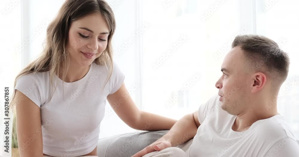 Young couple in pajamas talking with each other at home Young couple in pajamas talking with each other at home