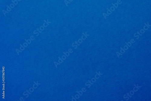 Coloured paper texture for background. Copy space. Saturated blue color. Colour trend of the year 2020.