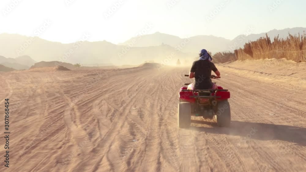 Quad bike ride through the desert near Sharm el Sheikh, Egypt.Adventures of desert off-road on ATV.Sand and Sand Borkhan. Rock and sunset. Quad Cycle Travel. Excursion with people. Quad bike ride through the desert near Sharm el Sheikh, Egypt.Adventures of desert off-road on ATV.Sand and Sand Borkhan. Rock and sunset. Quad Cycle Travel. Excursion with people.