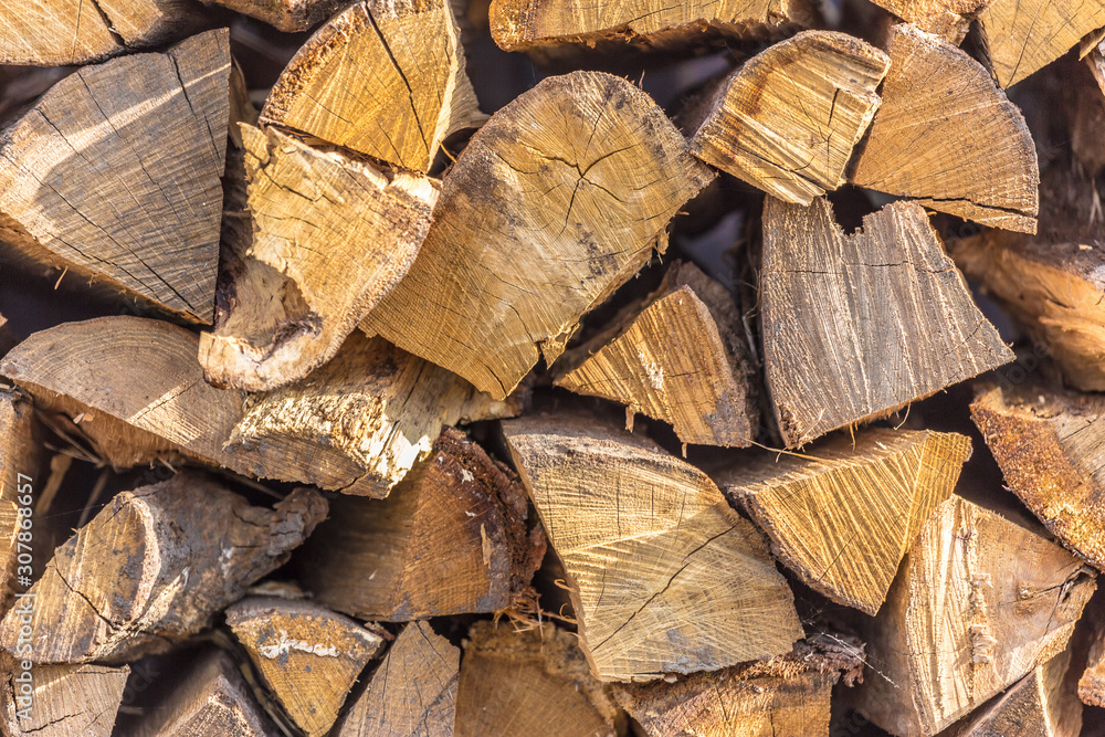 Wooden fire logs stacked up in the heap near the fence. Winter or Christmas background texture. Wooden fire logs stacked up in the heap near the fence. Winter or Christmas background texture.