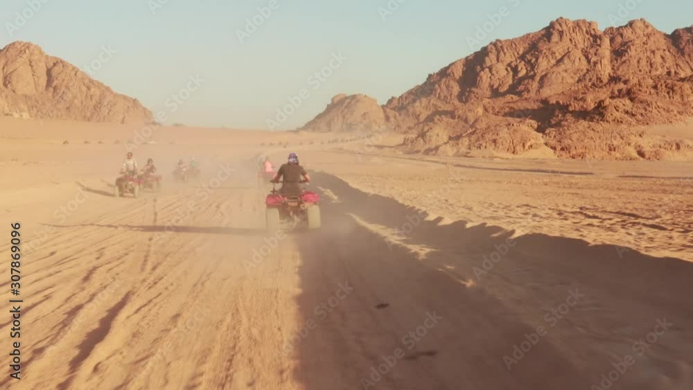 Quad bike ride through the desert near Sharm el Sheikh, Egypt.Adventures of desert off-road on ATV.Sand and Sand Borkhan. Rock and sunset. Quad Cycle Travel. Excursion with people. Quad bike ride through the desert near Sharm el Sheikh, Egypt.Adventures of desert off-road on ATV.Sand and Sand Borkhan. Rock and sunset. Quad Cycle Travel. Excursion with people.