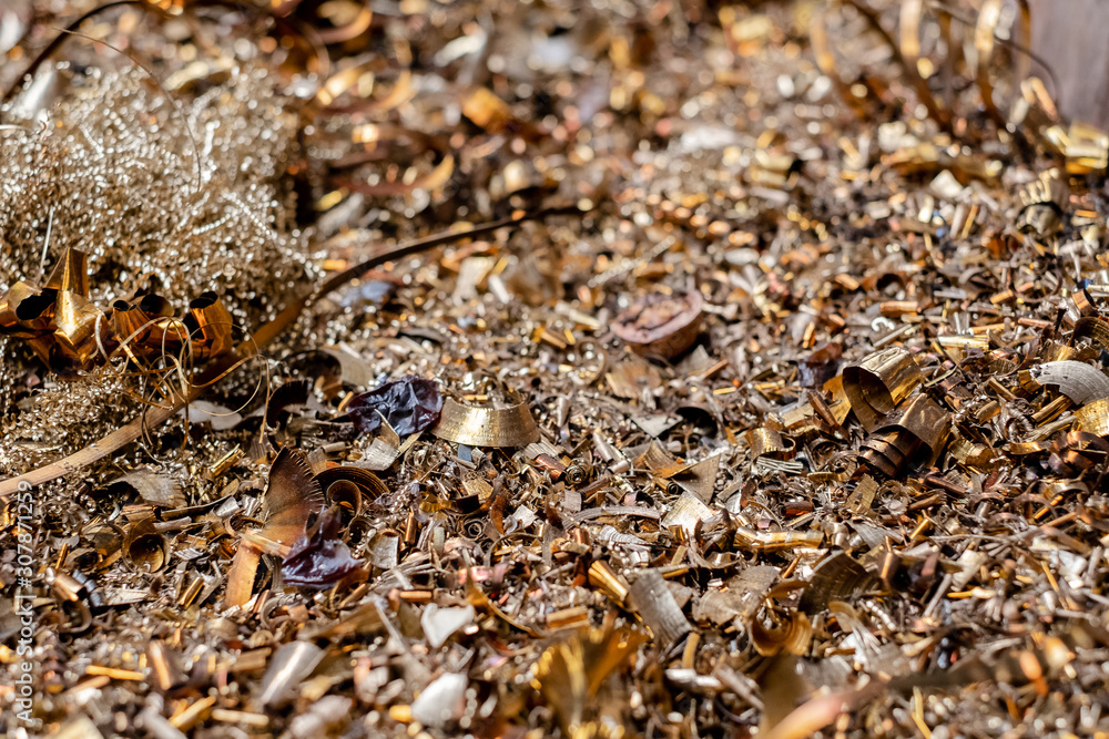 A lot of metal shavings lies in a container in a manufactory. A lot of metal shavings lies in a container in a manufactory.