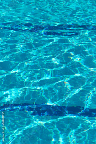 Abstract blurred background of pool water texture. Bright fashionable color of Aqua Menthe water. Vertical, free space. Design concept. © Nataliia