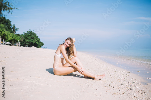 Delighted lady resting on tropical beach