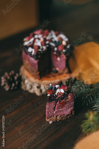 Christmas pink cake with flowers decor on wooden background with bokeh and sparkler