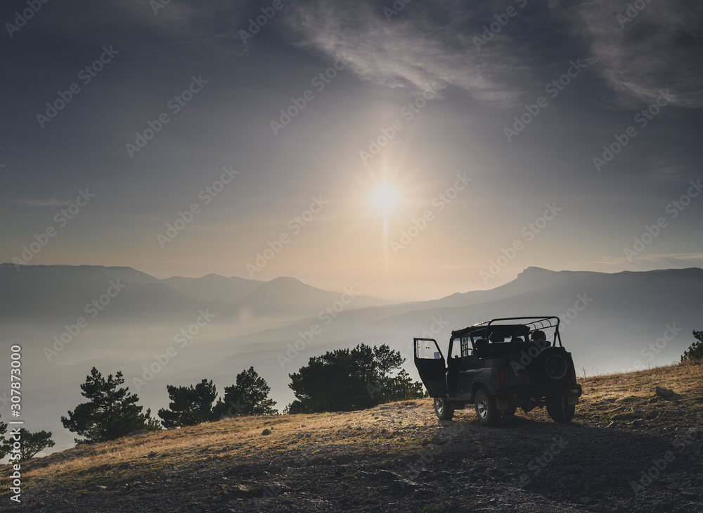Fototapeta premium Off road car on top of mountain at sunrise or sunset