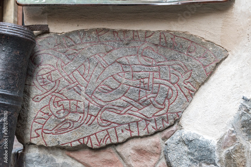 Viking runestone built into a wall in Gamla Stan (Old Town) of Stockholm, Sweden. photo