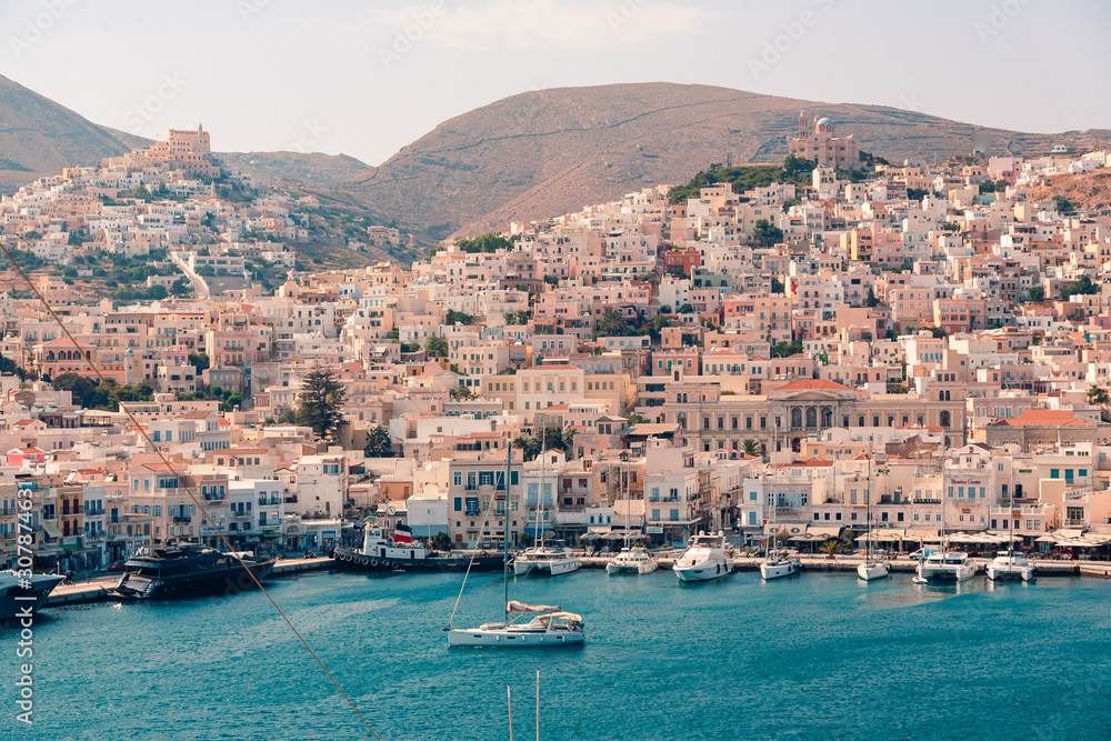 SYROS, GREECE - JUNE 26, 2019: casual from city port side streets and building at summer time