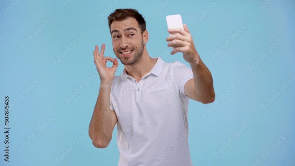 smiling man taking selfie isolated on blue smiling man taking selfie isolated on blue