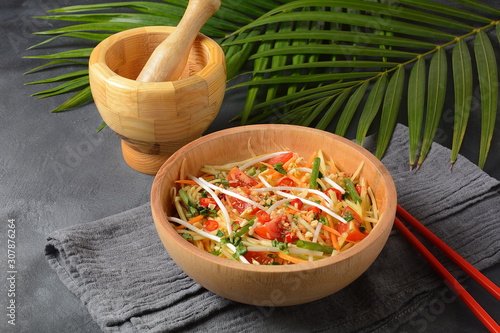 Delicious Som Tam -Thai green papaya salad) with green beans, tomatoes, peanuts. Thai street food . Healthy vegan foodgreen beans, tomatoes, peanuts. Thai street food . Healthy vegan food photo