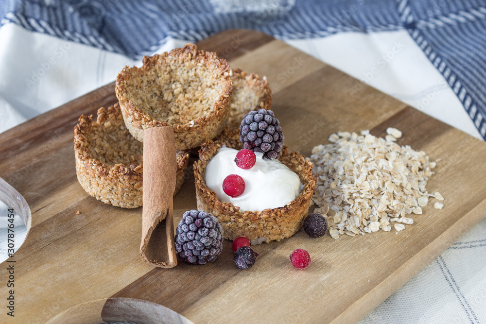 Fototapeta premium Homemade recipe made with oat flakes and natural yogurt filling, berries. Delicious and healthy breakfast snack preparation