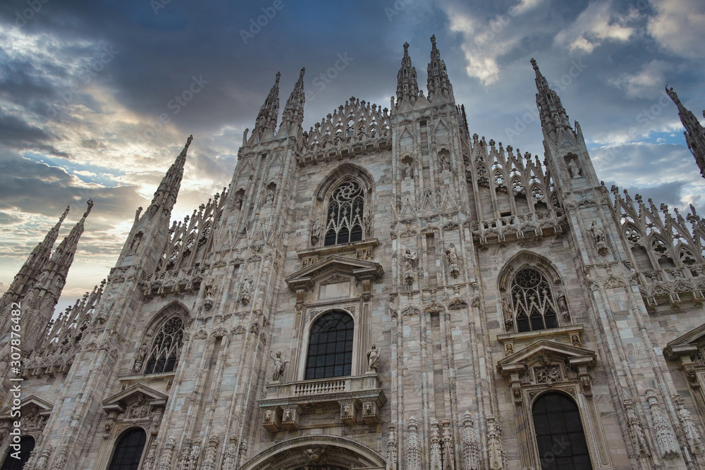 looking Duomo di Milano meaning Milan Cathedral in Italy, with blue sky