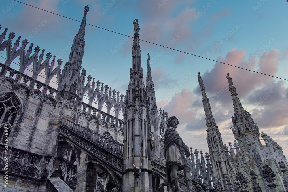looking Duomo di Milano meaning Milan Cathedral in Italy, with blue sky