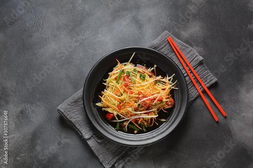 Delicious Som Tam -Thai green papaya salad) with green beans, tomatoes, peanuts. Thai street food . Healthy vegan foodgreen beans, tomatoes, peanuts. Thai street food . Healthy vegan food photo