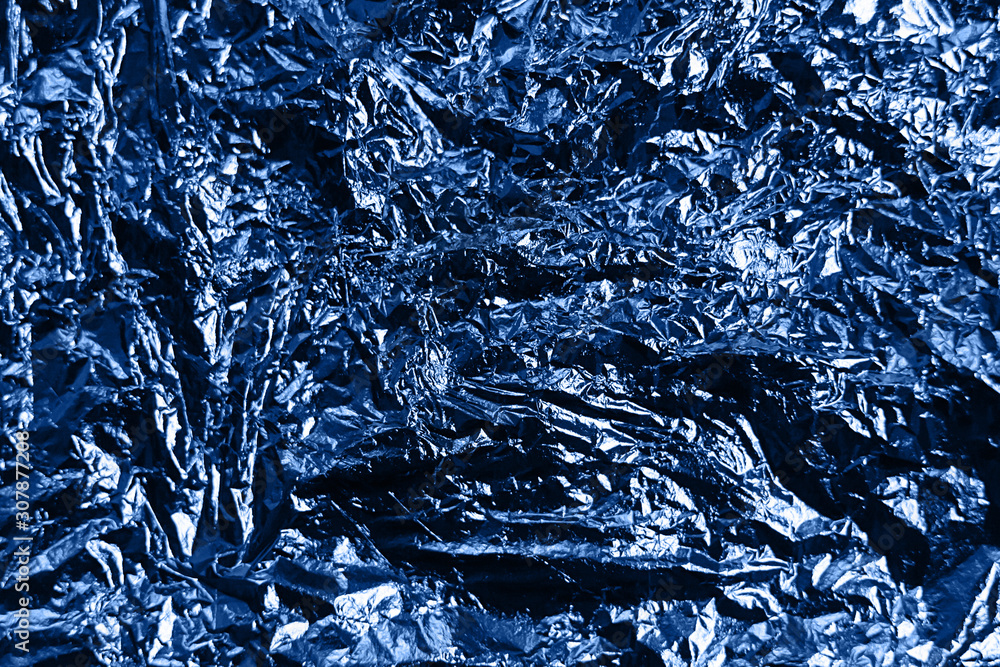 Metallic wrapping paper. Classic blue color of the year 2020. Overlapping glowing and twinkling spots decorative backdrop design. Crumpled foil creates vivid contrast and highlights Metallic wrapping paper. Classic blue color of the year 2020. Overlapping glowing and twinkling spots decorative backdrop design. Crumpled foil creates vivid contrast and highlights