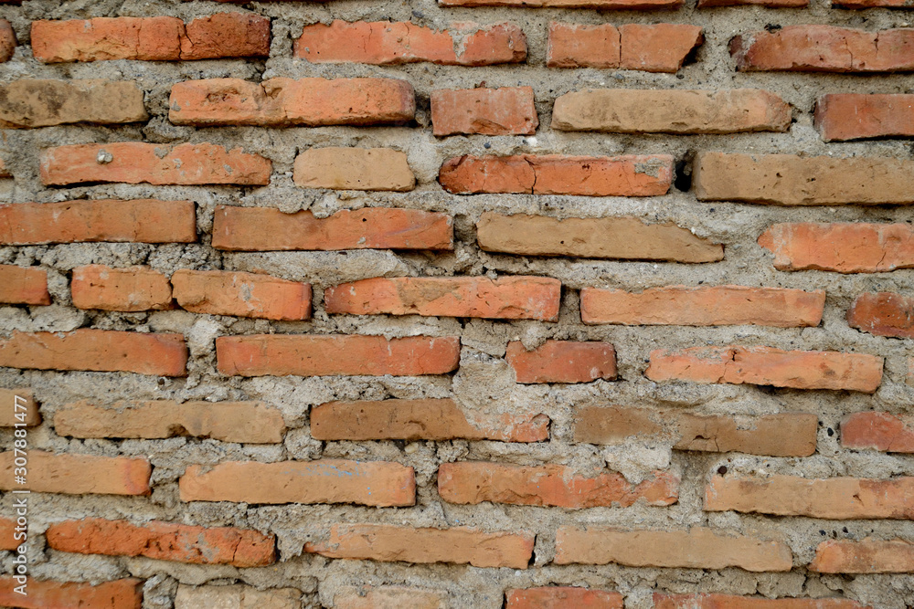 The red brick wall that has begun to decay The red brick wall that has begun to decay