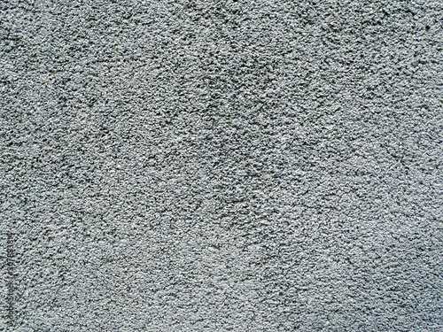 Rough texture of an old grey wall with visible pattern of applying the cement and other materials on an old and aged building
