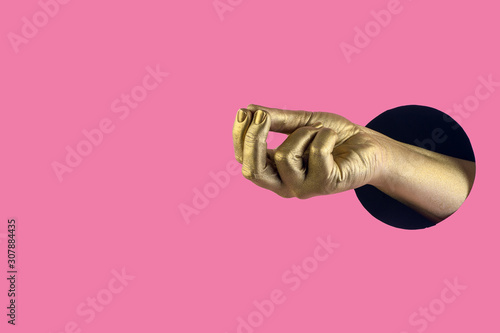Hand painted in gold shows different gestures and symbols from the hole on a pink pastel paper background.