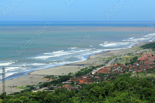 Bantul, Indonesia, March 13, 2015. The coastline view of Parangtritis beach to Parangkusumo beach seen from above is an attraction for tourists coming to Yogyakarta photo