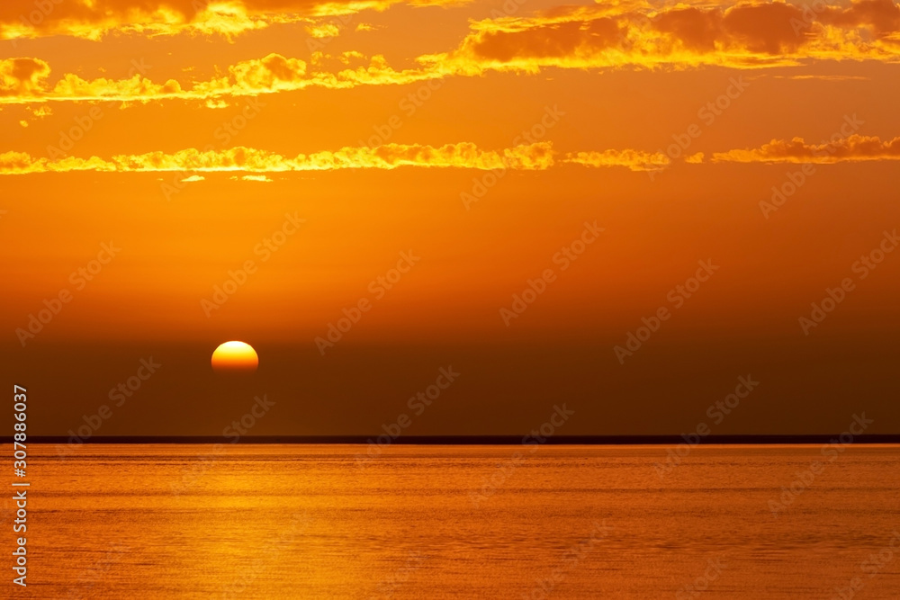 Beautiful golden sunset and bright sky over the lagoon