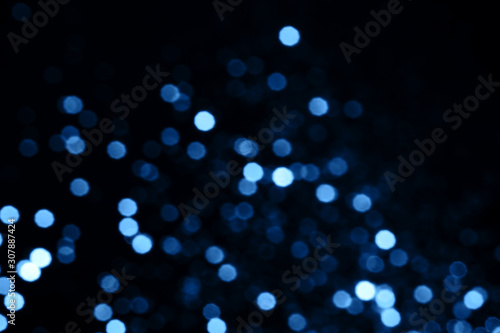 Splash of golden sparkles on black background. Blue color of the year 2020 concept.