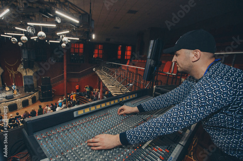 Remote recordists closeup. Electric machine on table for working of sound designer or club dj at party in nightclub. Objects for listen at background. Musical player for tuning of stage photo