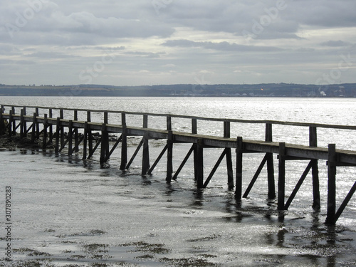 Long wooden pier on an overcast day in Scotland
