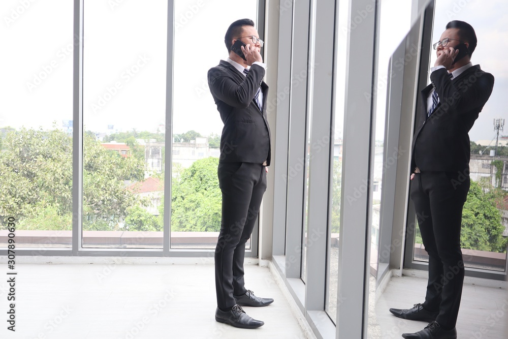 two businessmen shaking hands in front of office building two businessmen shaking hands in front of office building