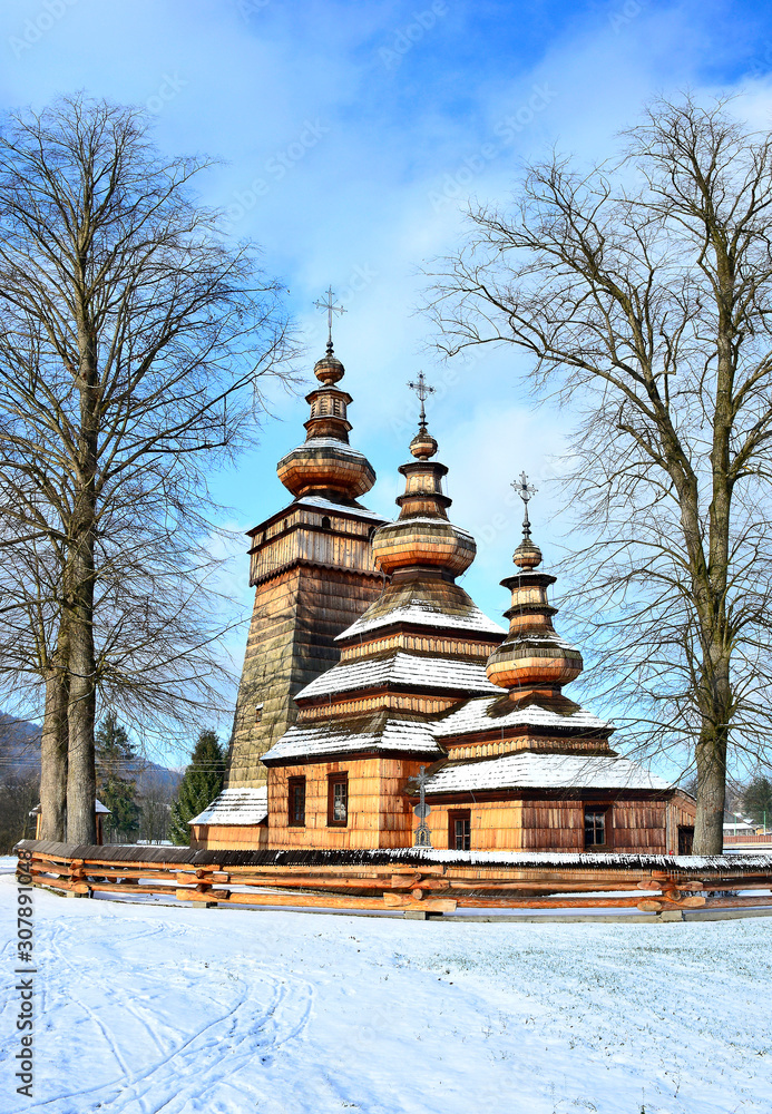 Ancient greek catholic wooden church in Kwiaton village at winter time - a classic example of Lemko church architecture,  UNESCO, Beskid Niski, Poland