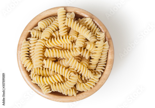 Photos Uncooked fusilli pasta in wooden bowl isolated on white background with clipping